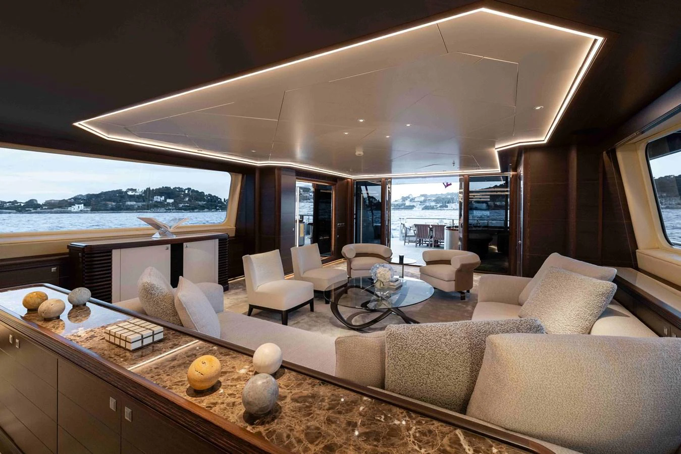 The yacht's salon offers a spacious and luxurious seating area with panoramic views. aboard AURA Yacht for Sale