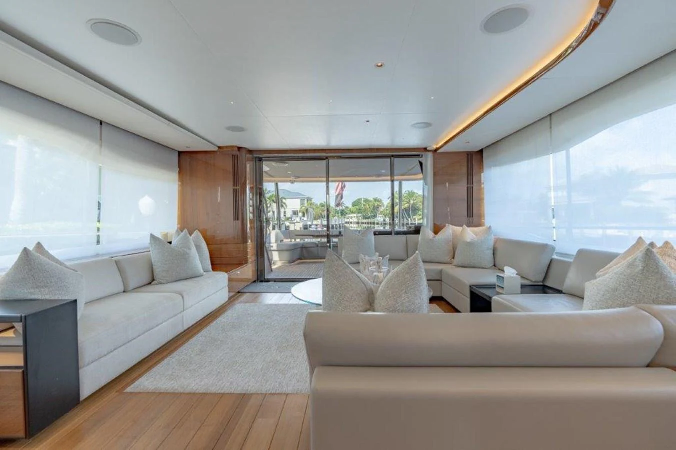 The salon features luxurious seating with ample natural light and elegant decor. aboard KAOS Yacht for Sale