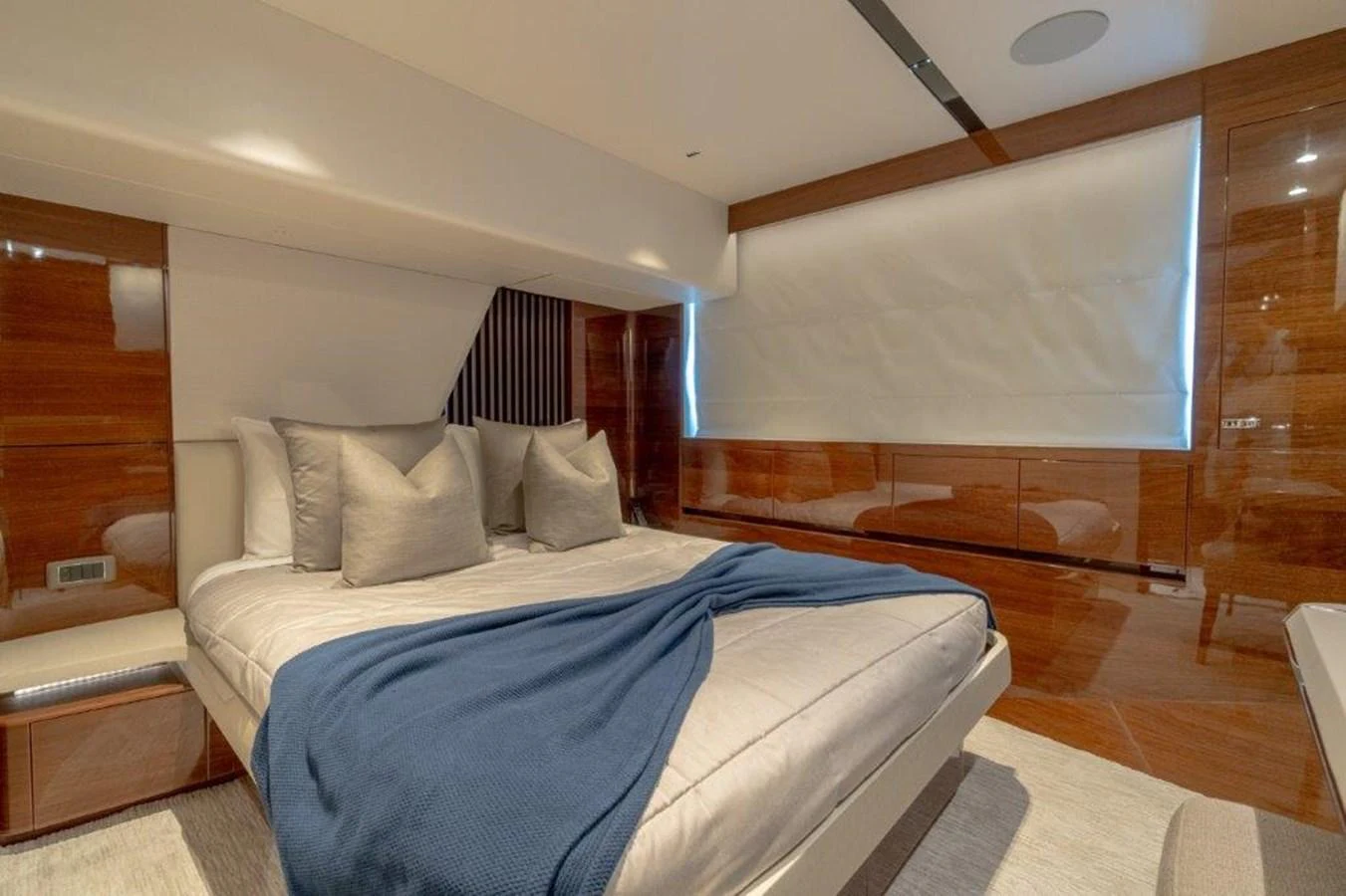 The stateroom features a plush bed with elegant bedding and a modern, sophisticated design. aboard KAOS Yacht for Sale
