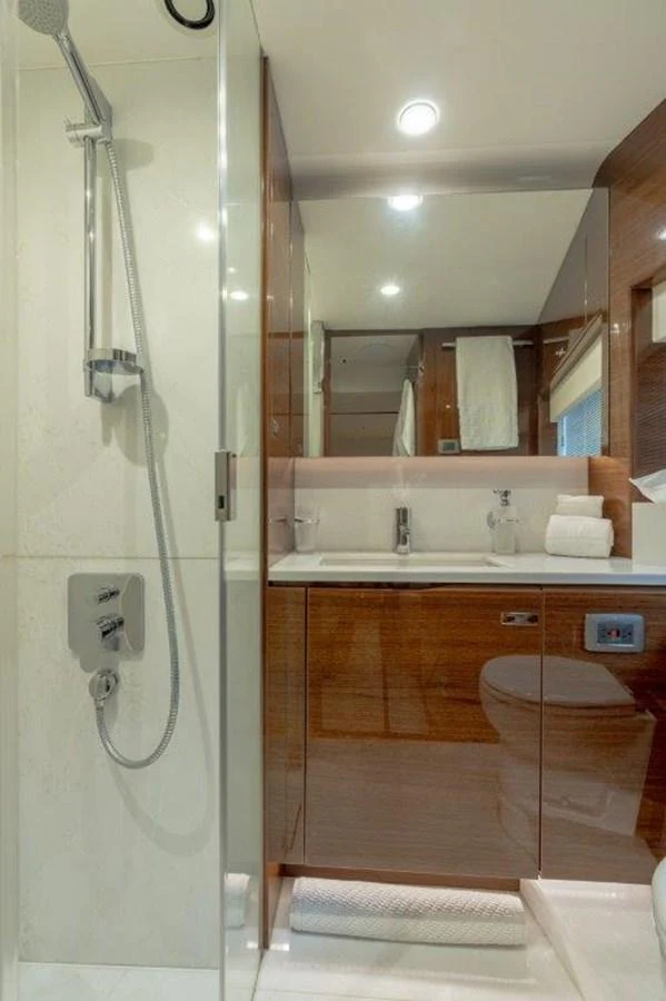 The yacht's bathroom features a sleek design with modern fixtures and ample lighting. aboard KAOS Yacht for Sale