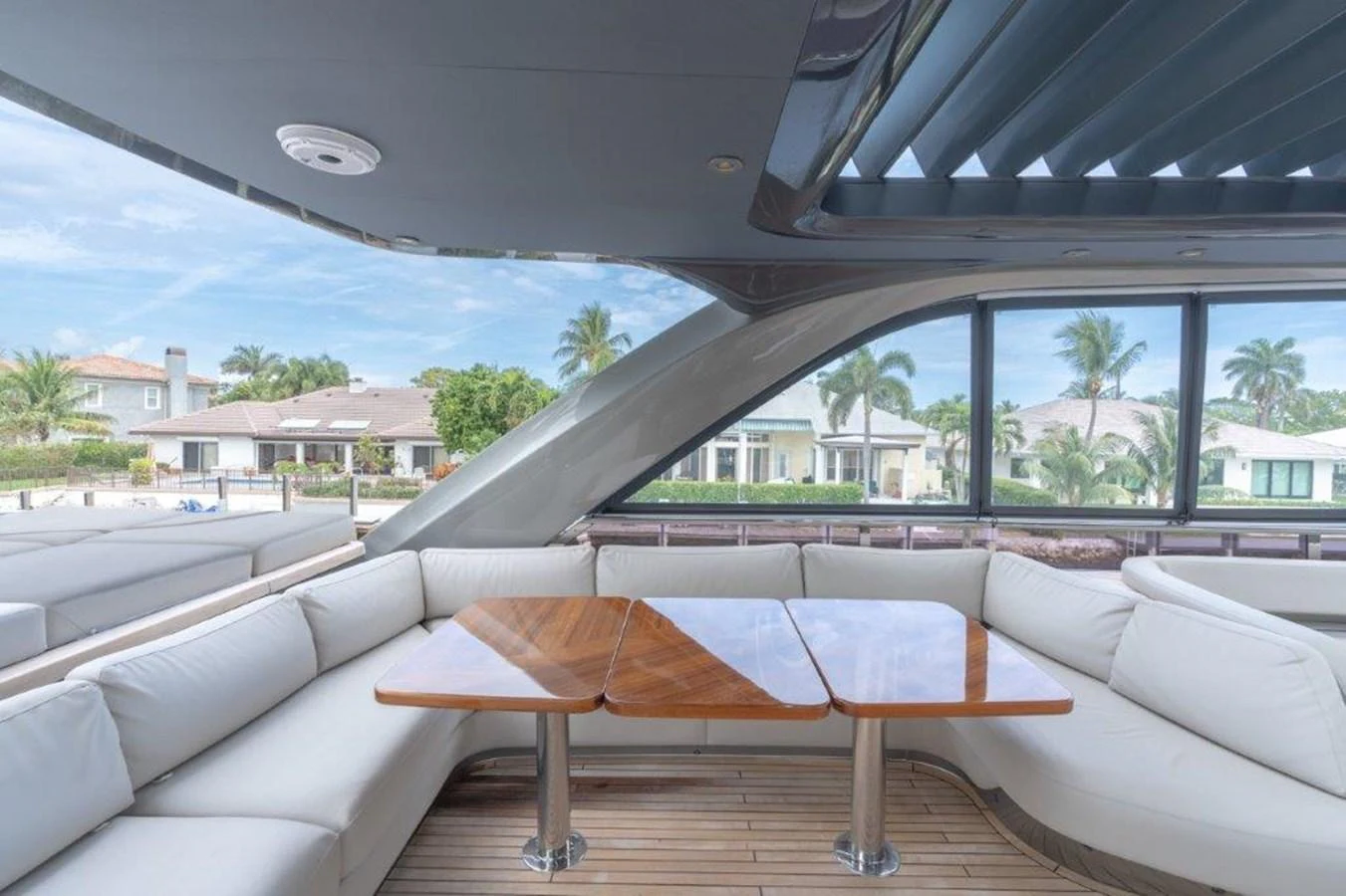 The salon features a spacious seating area with elegant wooden tables and large windows offering scenic views. aboard KAOS Yacht for Sale