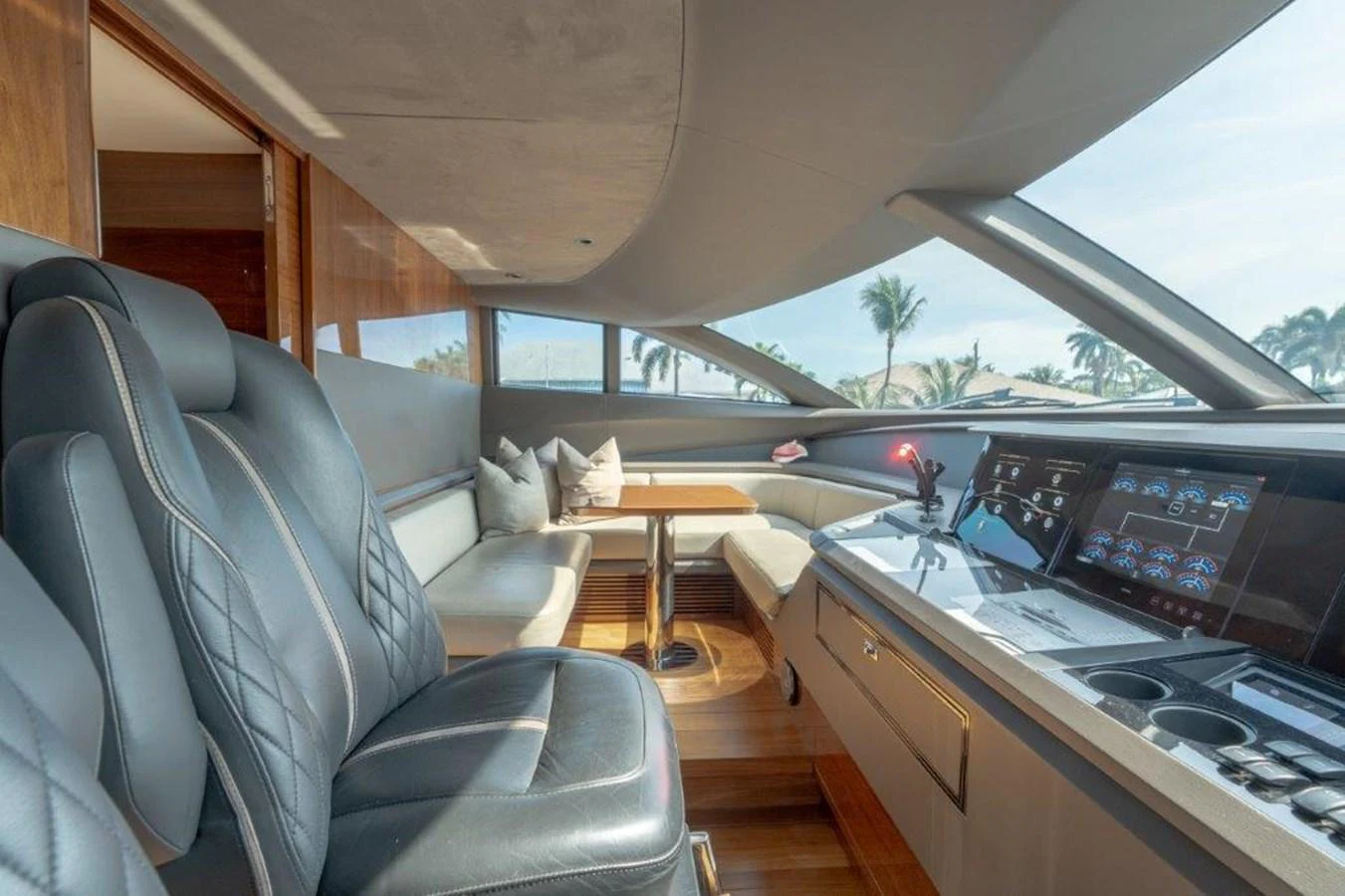The helm station features luxurious seating and state-of-the-art navigation equipment with a panoramic view. aboard KAOS Yacht for Sale
