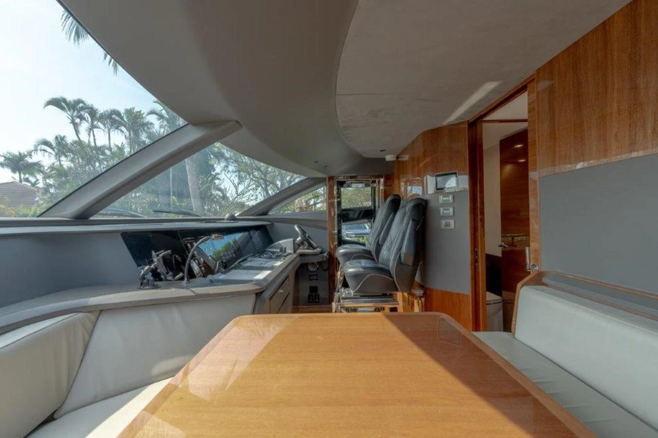 The helm area features a sleek design with modern controls and comfortable seating. aboard KAOS Yacht for Sale