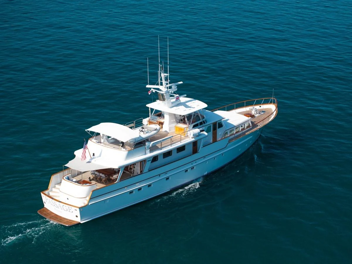 A classic yacht cruises gracefully on the open sea, showcasing its elegant design and spacious decks. aboard PASSAGE Yacht for Sale