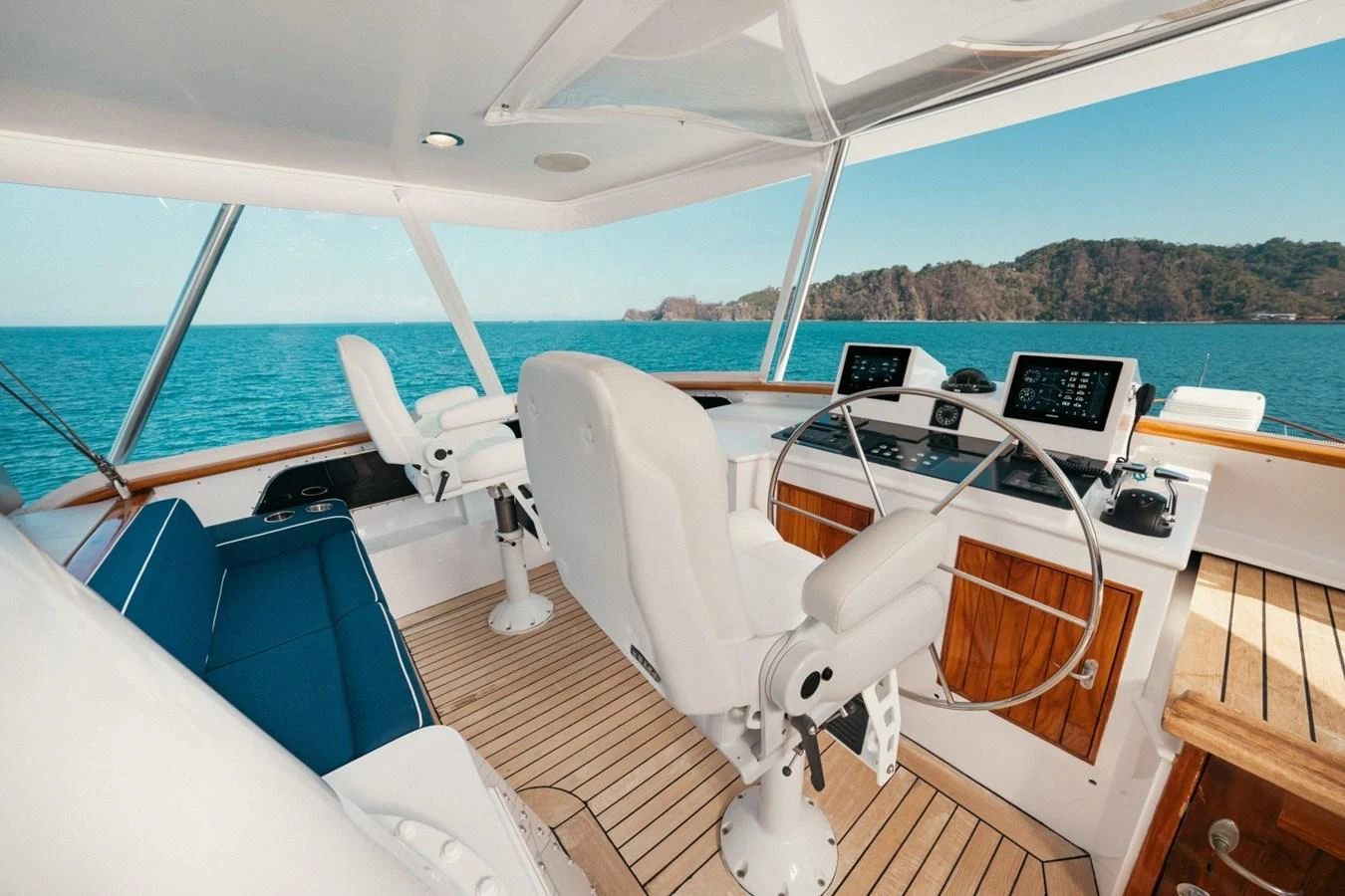 The helm station offers a commanding view with modern navigation equipment and comfortable seating. aboard PASSAGE Yacht for Sale