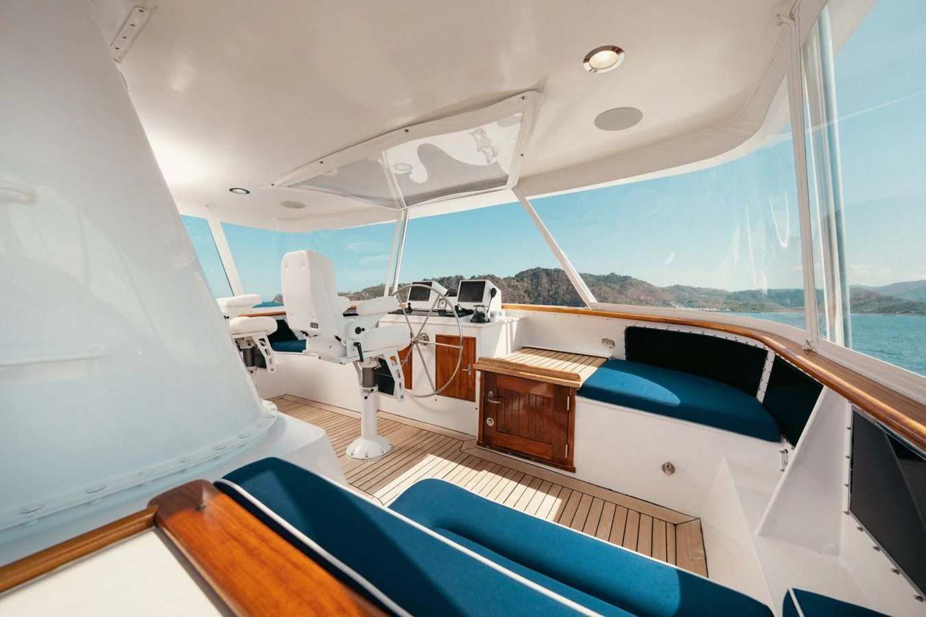 The helm area offers a spacious and well-lit environment with comfortable seating and modern navigation equipment. aboard PASSAGE Yacht for Sale