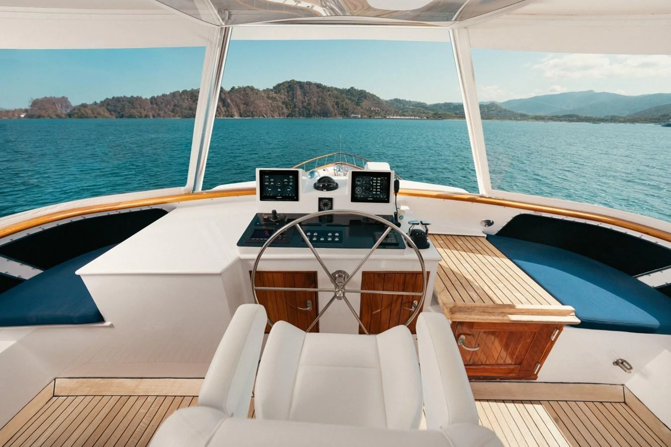 The helm station offers a commanding view of the serene waters and surrounding landscape. aboard PASSAGE Yacht for Sale