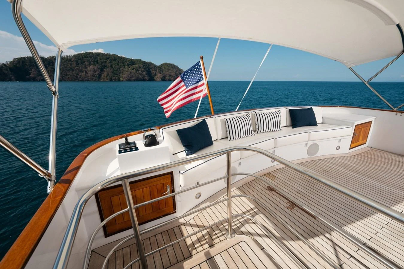 The aft deck offers a serene seating area with a stunning view of the sea, complemented by a patriotic touch. aboard PASSAGE Yacht for Sale