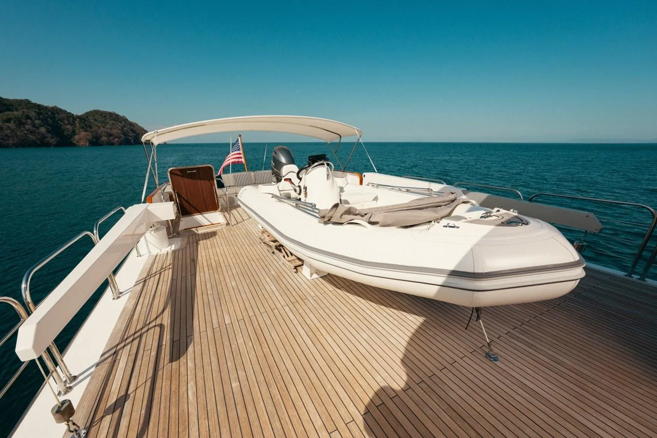 A sleek tender is securely positioned on the spacious aft deck of the yacht, ready for adventure. aboard PASSAGE Yacht for Sale