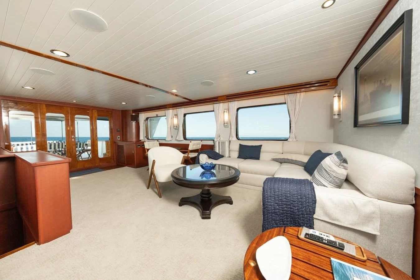 The salon offers a spacious and elegant seating area with large windows providing stunning ocean views. aboard PASSAGE Yacht for Sale