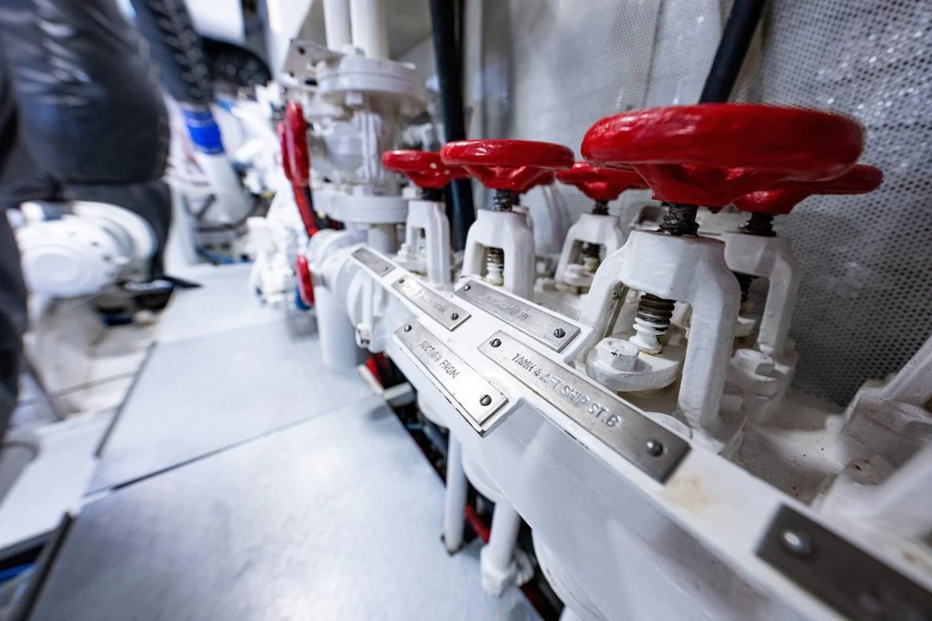A close-up view of the yacht's engine room showcasing various valves and mechanical components. aboard PASSAGE Yacht for Sale