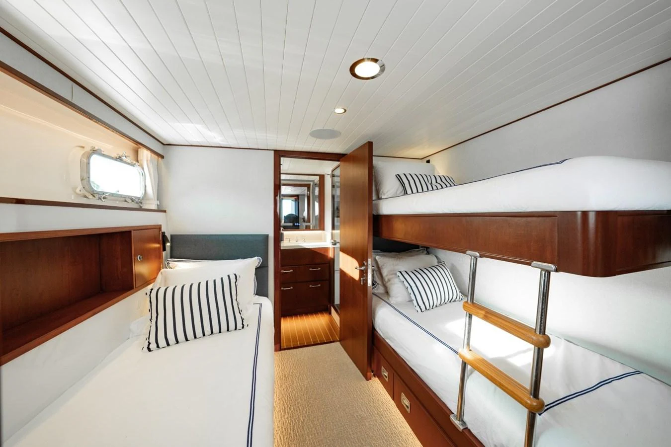 The guest cabin features cozy bunk beds and a warm, inviting atmosphere. aboard PASSAGE Yacht for Sale