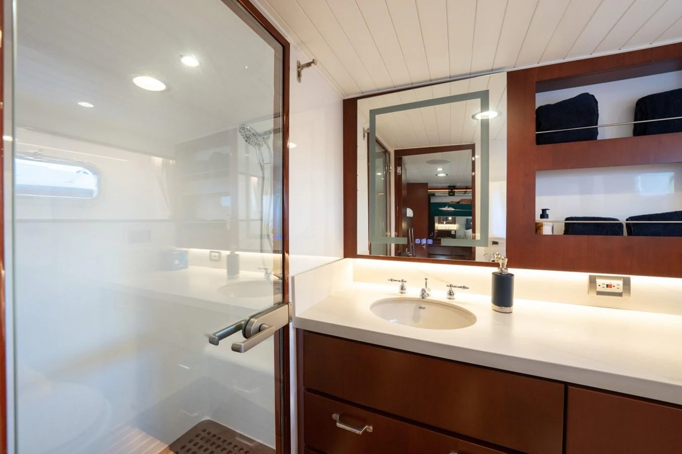 The yacht's bathroom features a sleek design with a spacious shower and modern fixtures. aboard PASSAGE Yacht for Sale