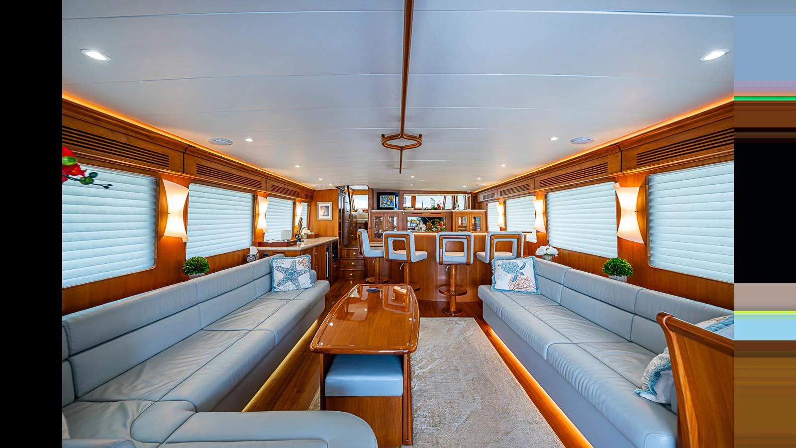 The salon features elegant seating with plush cushions and a sophisticated bar area. aboard TURANGALILA Yacht for Sale