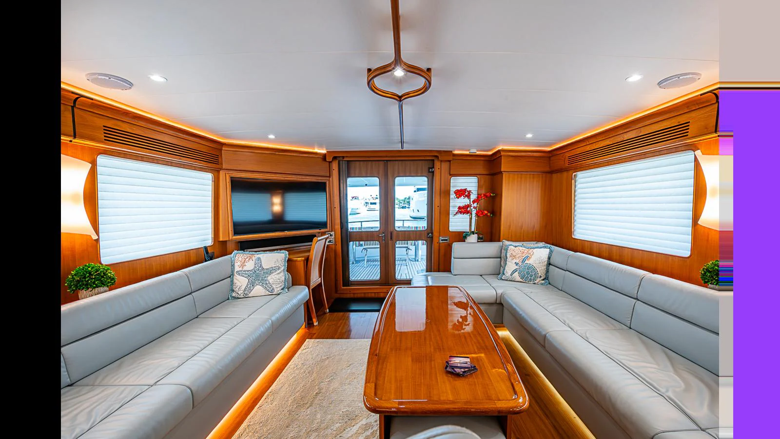 The salon features elegant wood finishes, plush seating, and ample natural light. aboard TURANGALILA Yacht for Sale