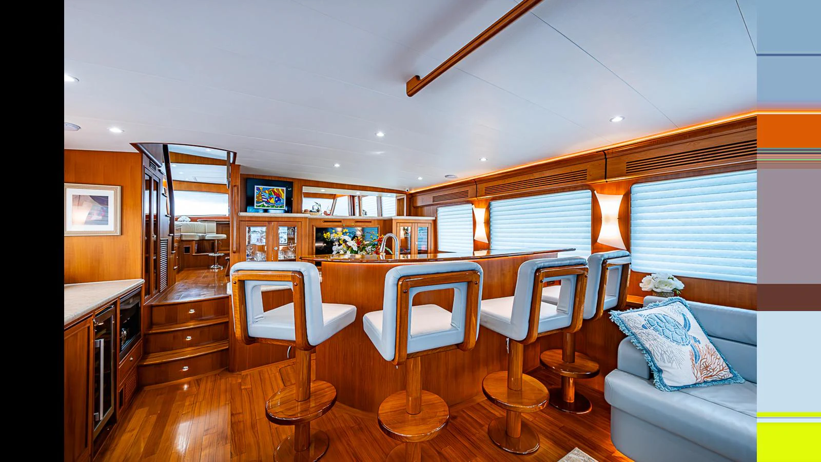 The salon features a cozy seating area with bar stools and a comfortable couch, perfect for relaxation and entertainment. aboard TURANGALILA Yacht for Sale
