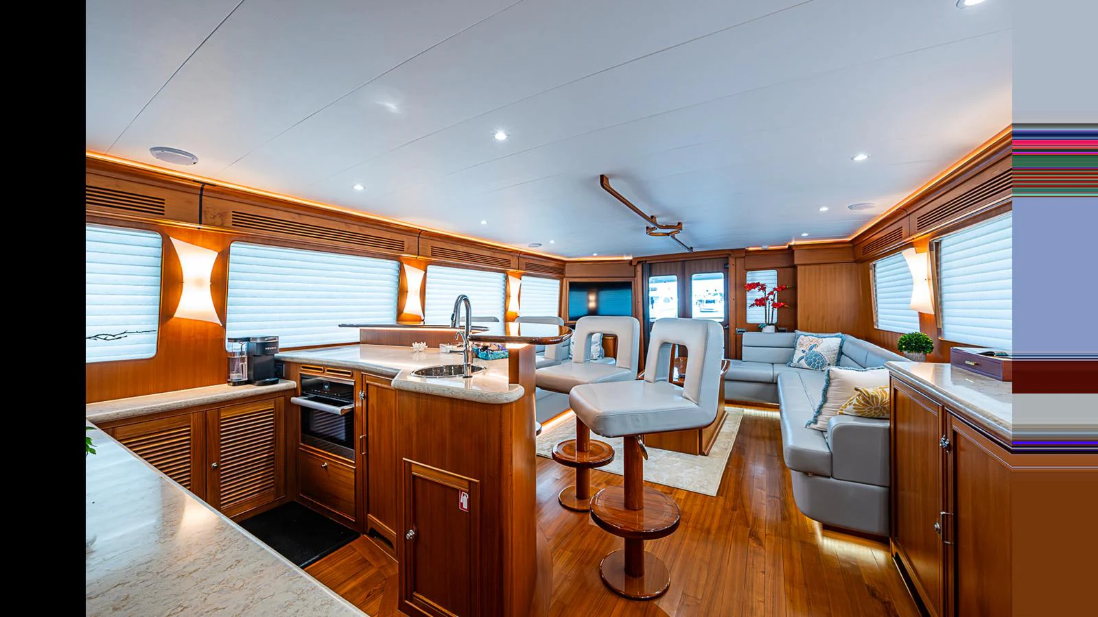The spacious salon features elegant wood finishes, comfortable seating, and modern amenities. aboard TURANGALILA Yacht for Sale