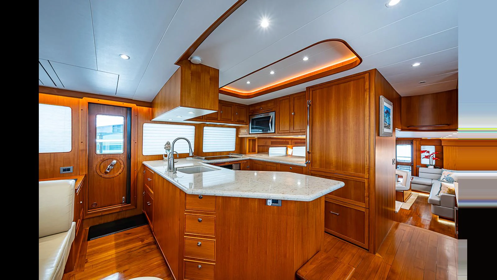 The yacht's galley features rich wood cabinetry, modern appliances, and a spacious layout for gourmet cooking. aboard TURANGALILA Yacht for Sale
