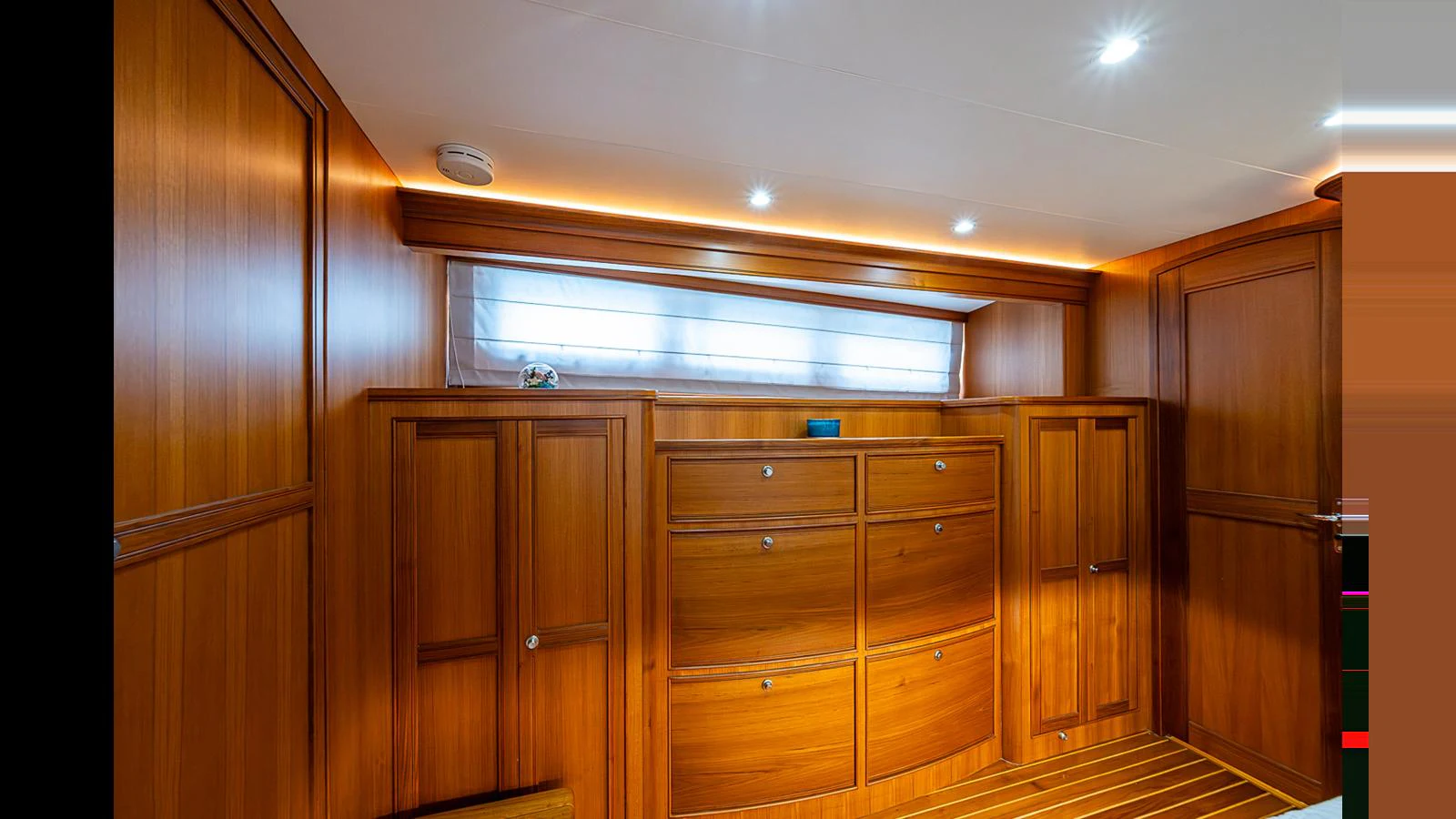The yacht's interior features elegant wooden cabinetry and ample storage space. aboard TURANGALILA Yacht for Sale
