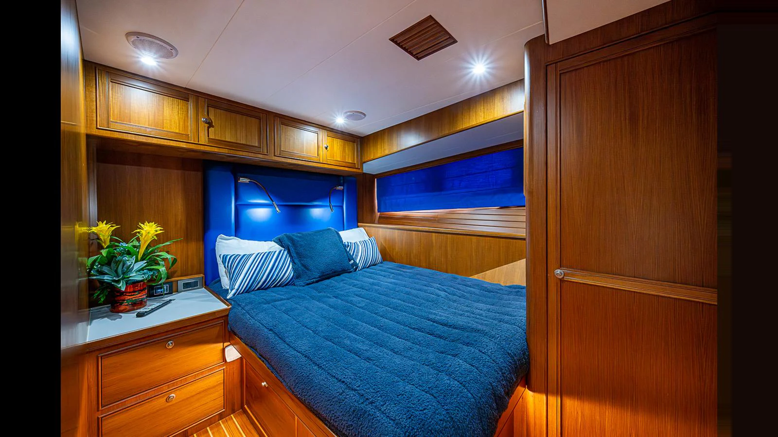 A cozy stateroom with a plush bed and warm wooden finishes. aboard TURANGALILA Yacht for Sale
