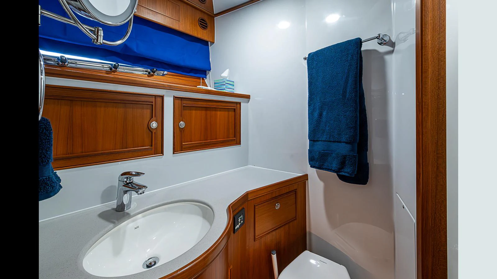 This yacht bathroom features elegant wooden cabinetry and modern fixtures. aboard TURANGALILA Yacht for Sale