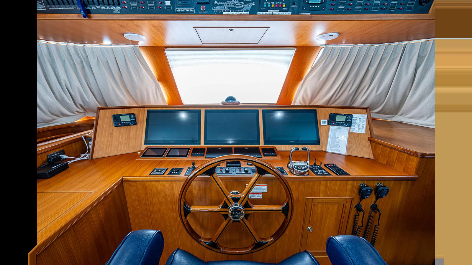 The helm station features state-of-the-art navigation equipment and luxurious wood finishes. aboard TURANGALILA Yacht for Sale