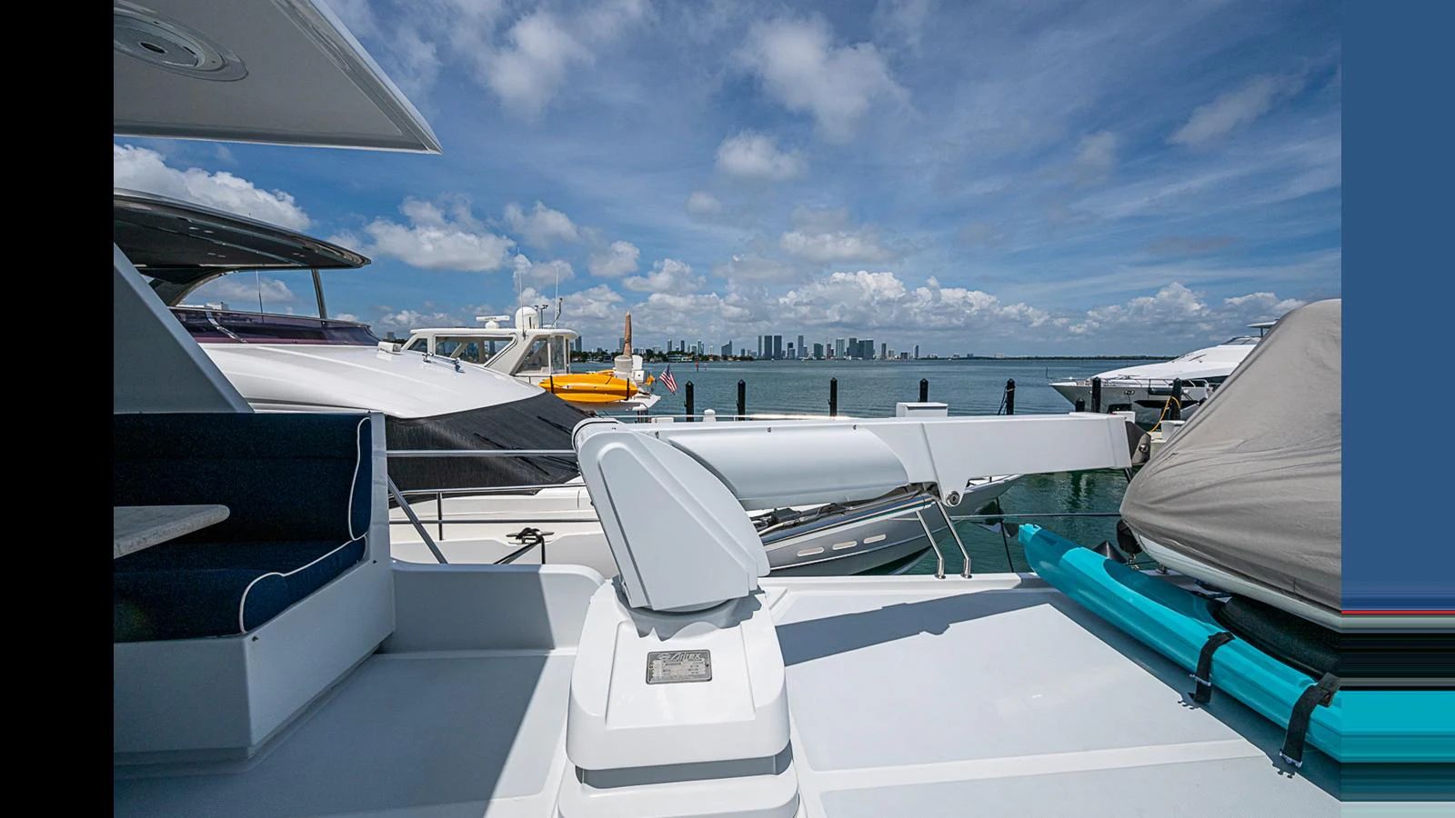 The yacht's deck offers a spacious and inviting area with a stunning view of the city skyline in the background. aboard TURANGALILA Yacht for Sale