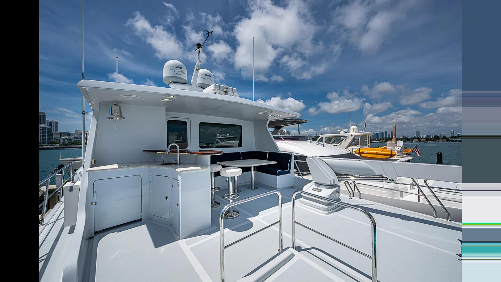 The flybridge offers a spacious and inviting area with seating and a bar for outdoor enjoyment. aboard TURANGALILA Yacht for Sale