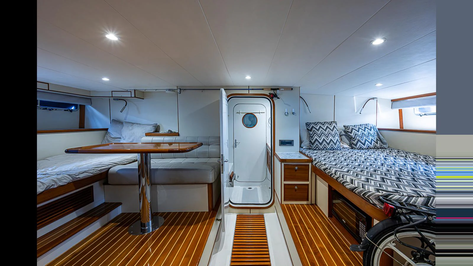 The cabin features cozy sleeping areas with modern bedding and a compact, functional layout. aboard TURANGALILA Yacht for Sale