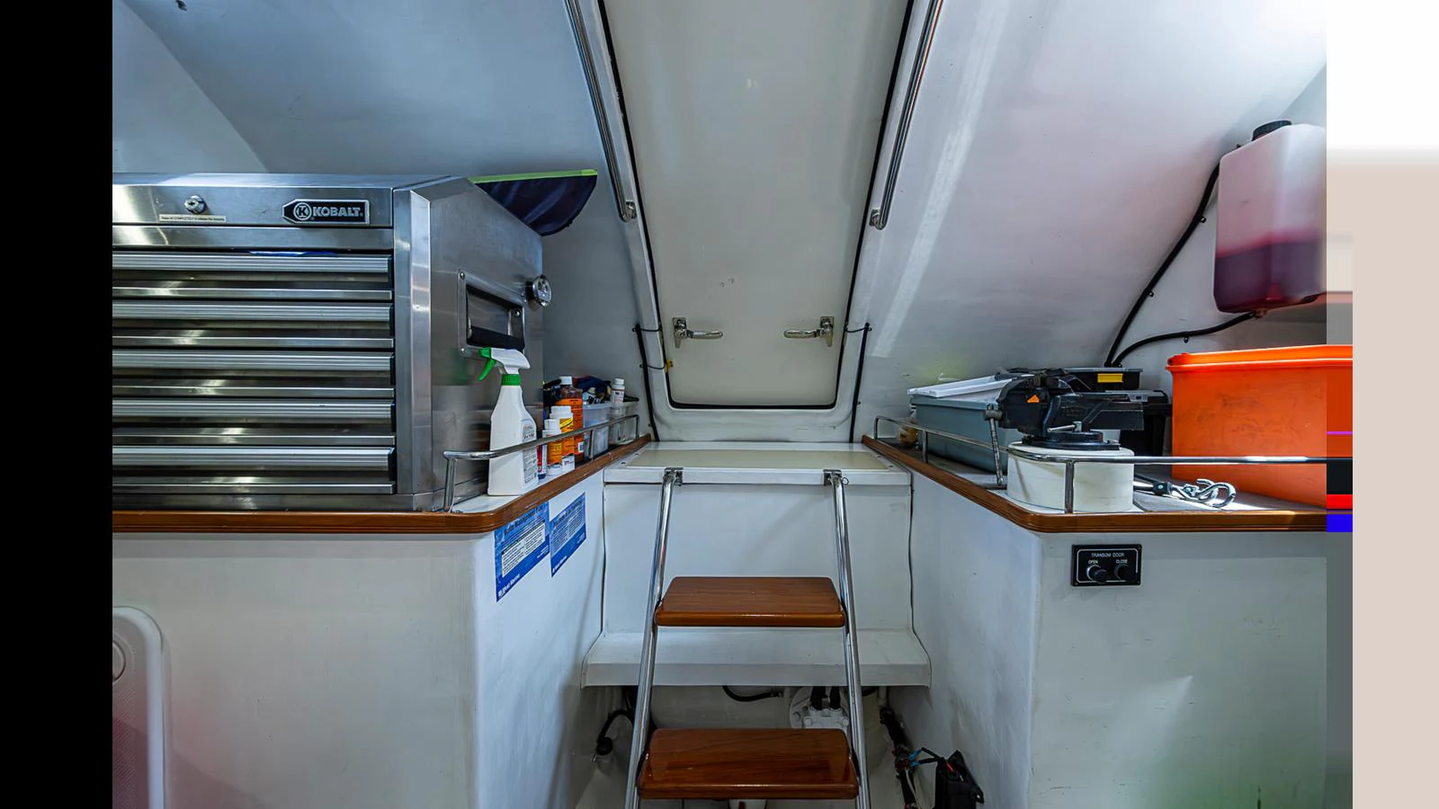 A well-organized utility area with a ladder leading to an upper hatch. aboard TURANGALILA Yacht for Sale