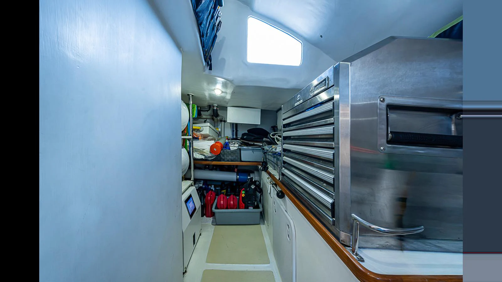 A functional interior space equipped with storage and equipment, showcasing the yacht's practical design. aboard TURANGALILA Yacht for Sale