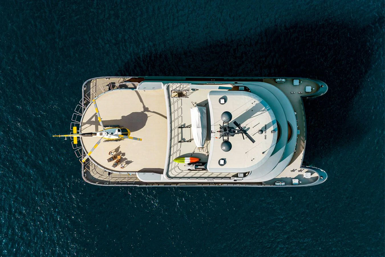 Aerial view of a luxurious yacht showcasing its spacious deck and sleek design. aboard NURJA Yacht for Sale