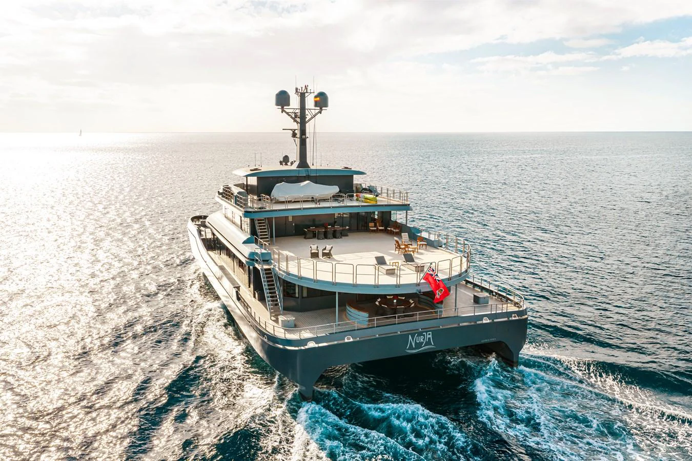 A luxurious yacht cruising on the open sea, showcasing its expansive decks and elegant design. aboard NURJA Yacht for Sale