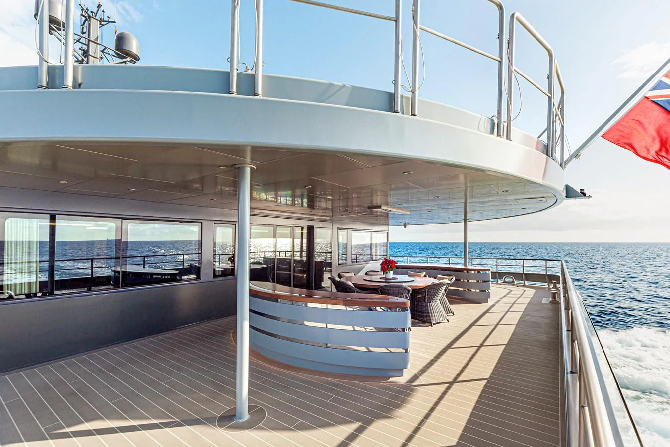 The aft deck offers a spacious and elegant area for outdoor dining and relaxation with stunning ocean views. aboard NURJA Yacht for Sale