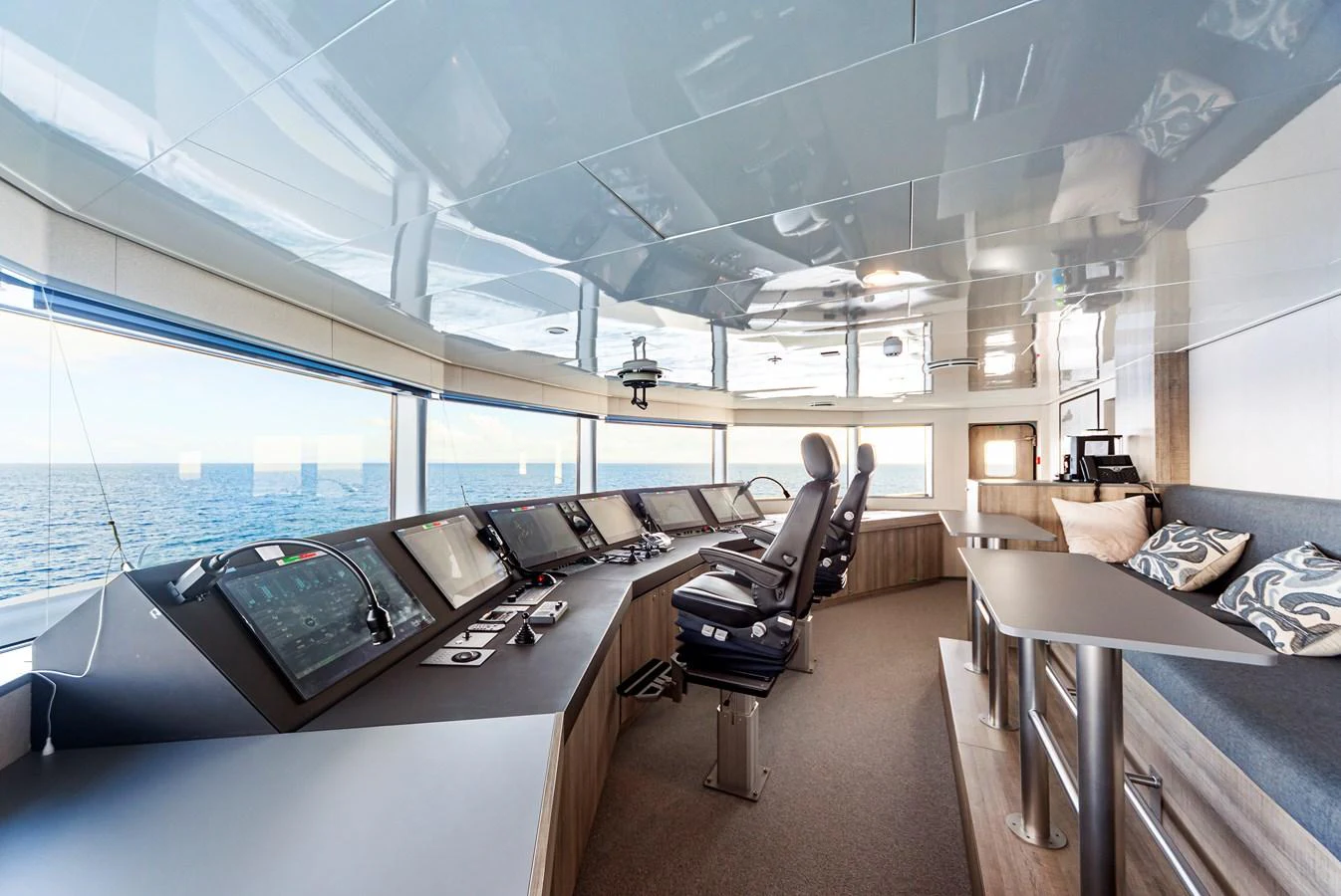 The yacht's helm station features state-of-the-art navigation equipment and a comfortable seating area with panoramic views. aboard NURJA Yacht for Sale