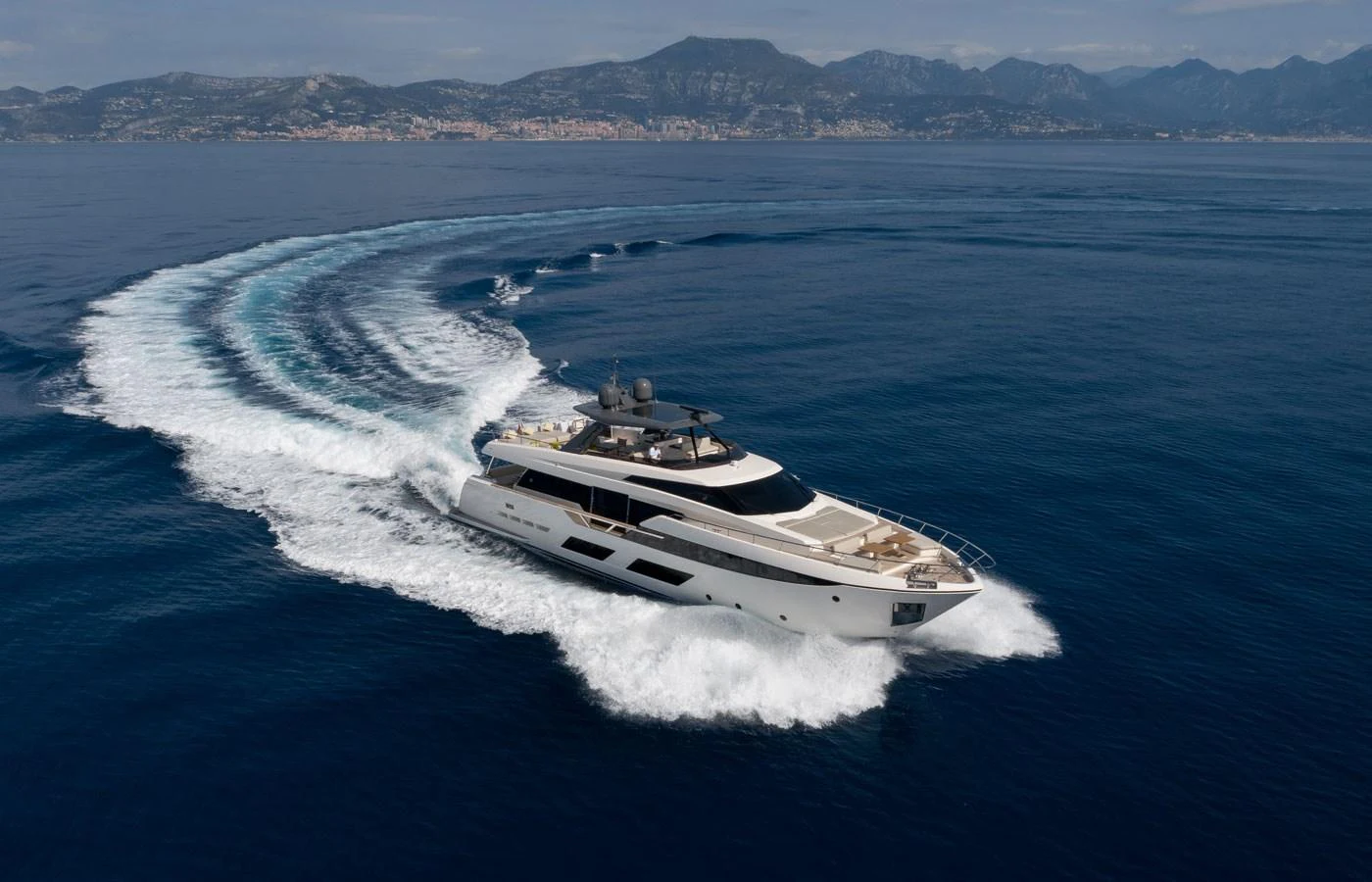 A sleek yacht glides through the open sea, leaving a trail of white wake behind. aboard ALEGRIA II Yacht for Sale