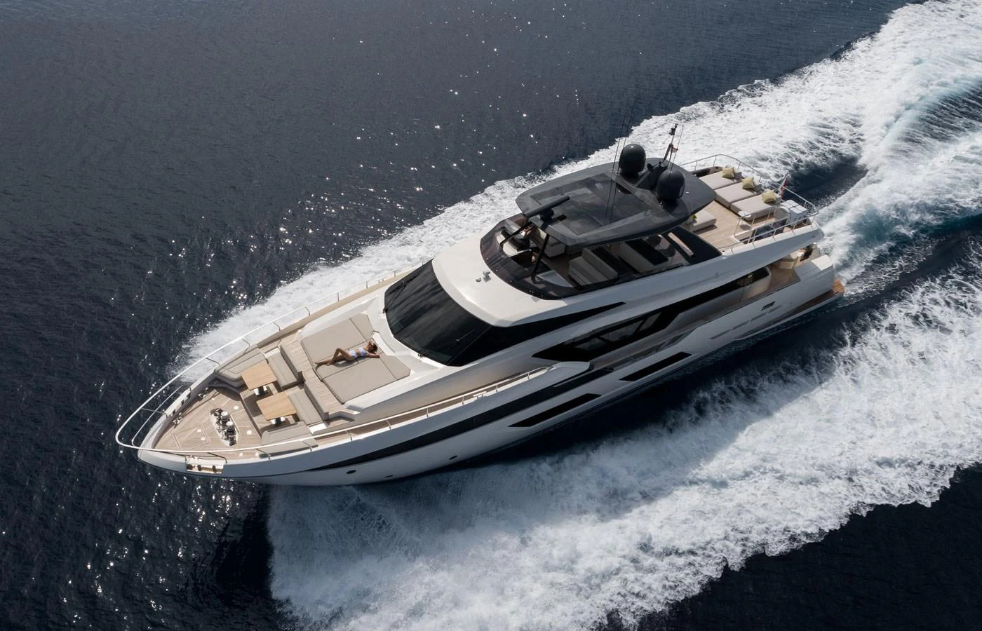 A sleek, modern yacht cruises swiftly through the water, showcasing its luxurious design and spacious deck areas. aboard ALEGRIA II Yacht for Sale