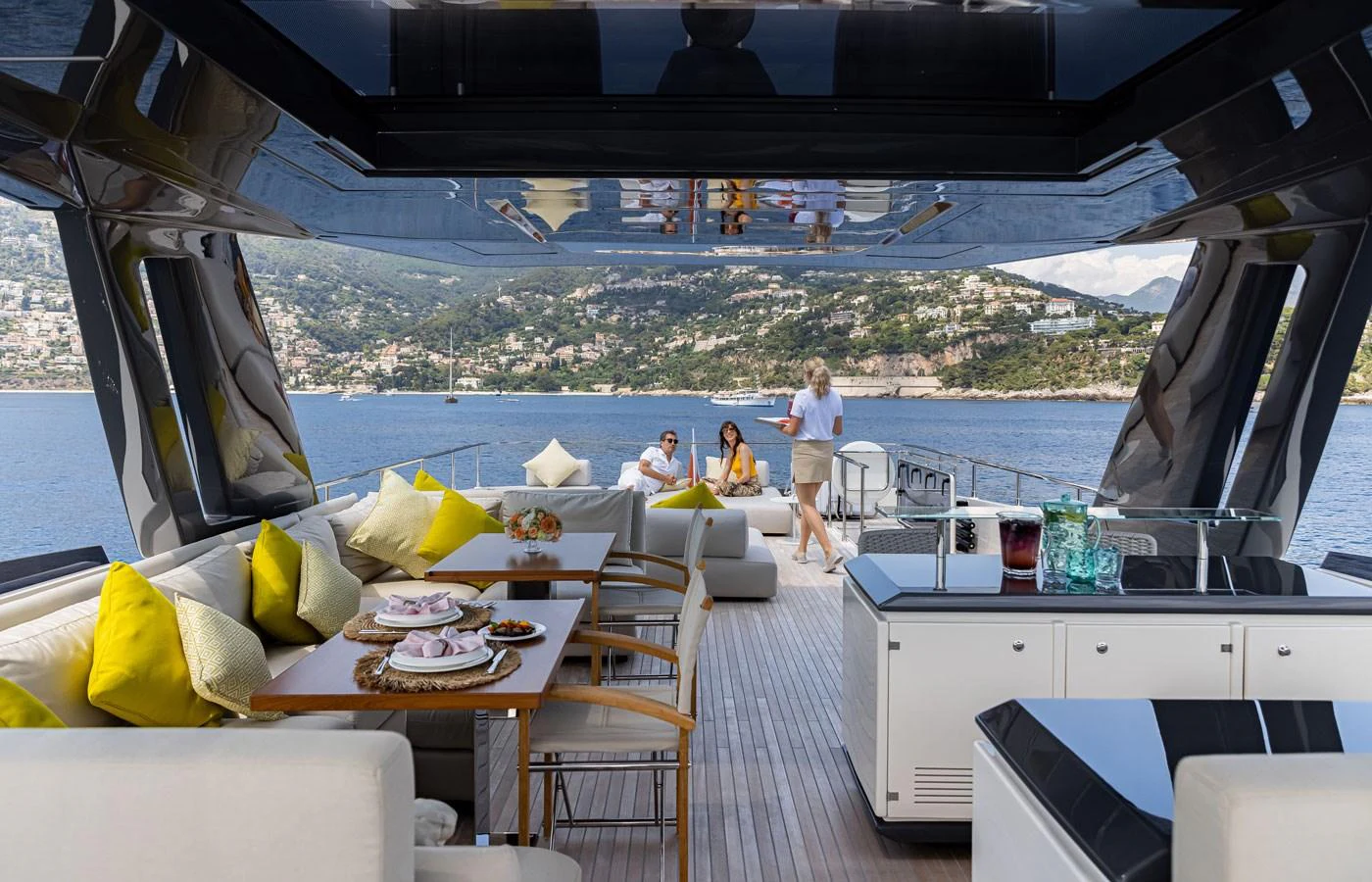 The aft deck features a spacious seating area with a dining table, perfect for enjoying meals with a view. aboard ALEGRIA II Yacht for Sale