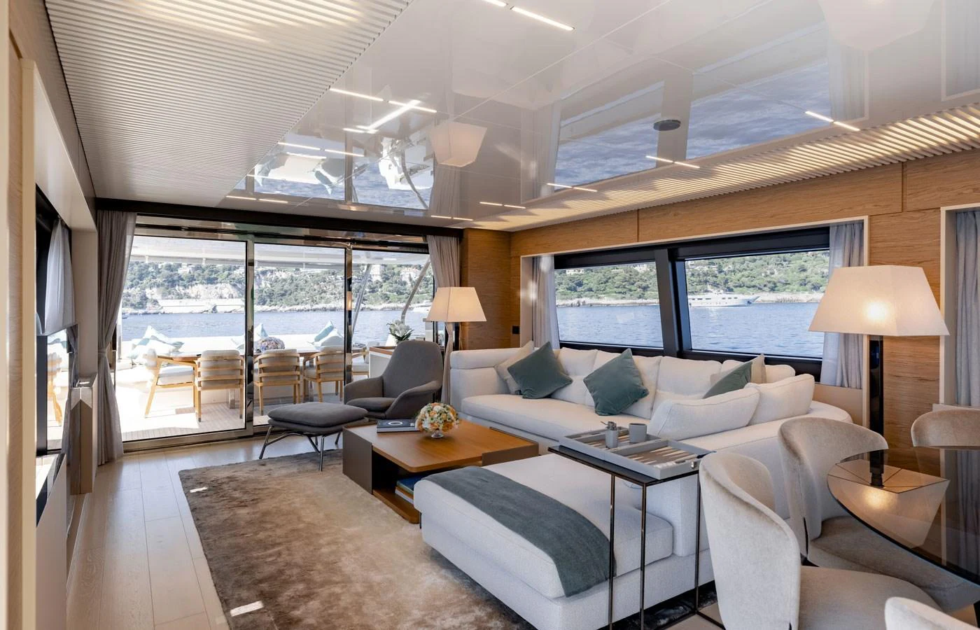 The salon offers a spacious and elegant seating area with large windows providing stunning views. aboard ALEGRIA II Yacht for Sale