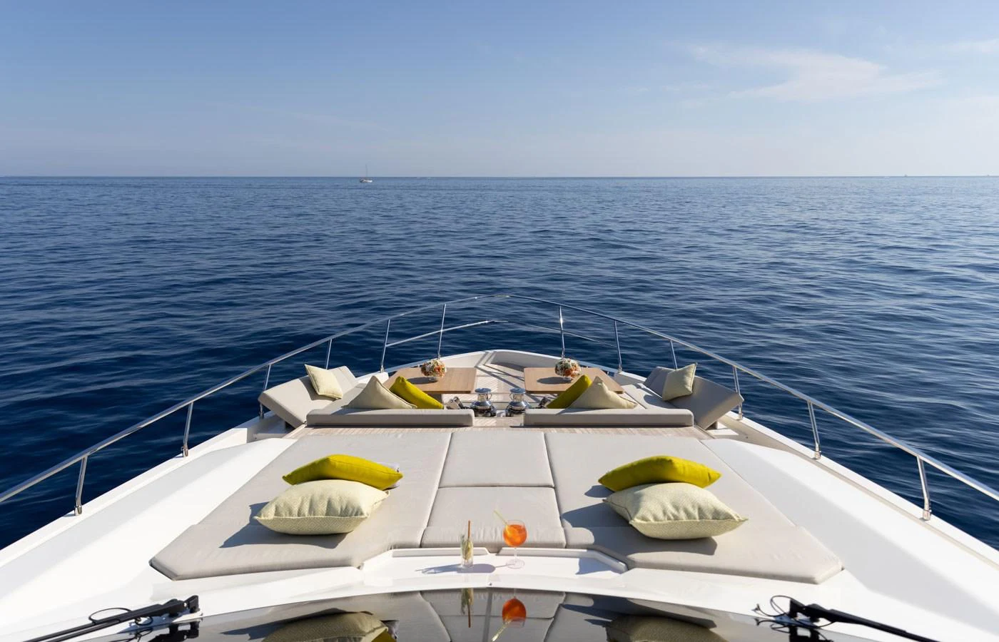 The foredeck offers a luxurious sunbathing area with plush cushions and a stunning ocean view. aboard ALEGRIA II Yacht for Sale