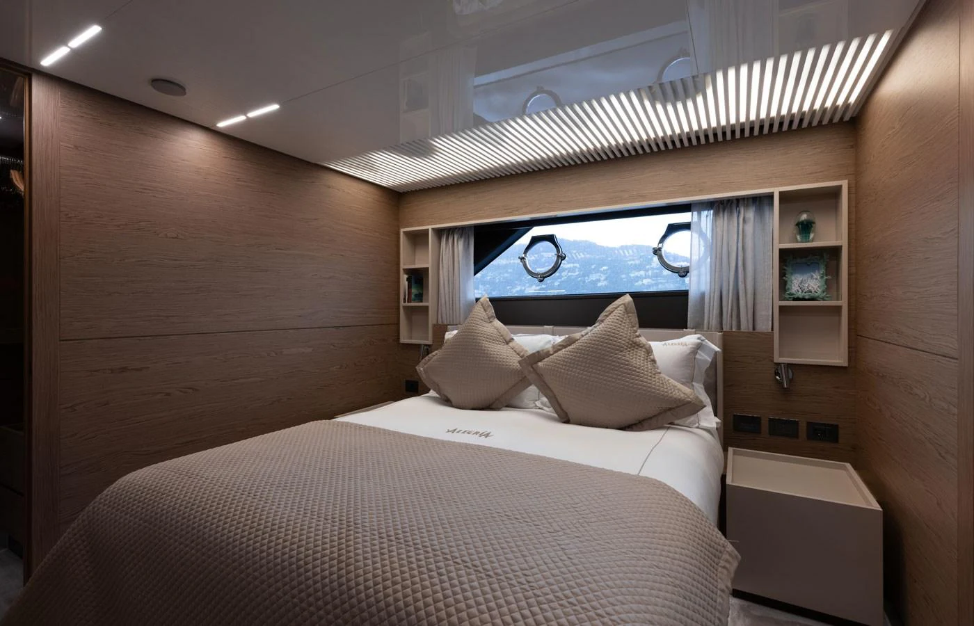 A cozy stateroom with a large bed and ample natural light from the window. aboard ALEGRIA II Yacht for Sale