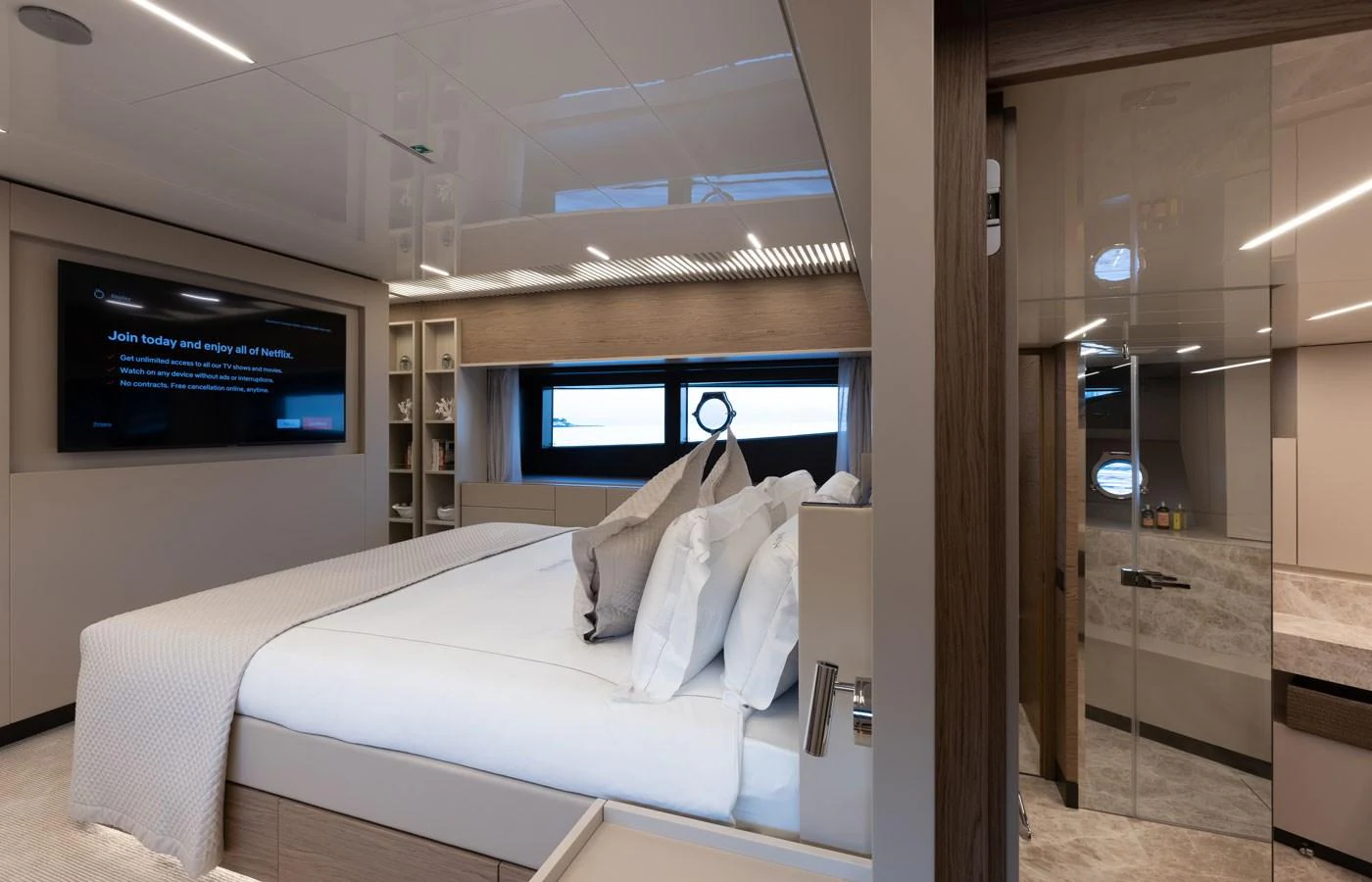 The stateroom features a luxurious bed with modern decor and ample natural light. aboard ALEGRIA II Yacht for Sale