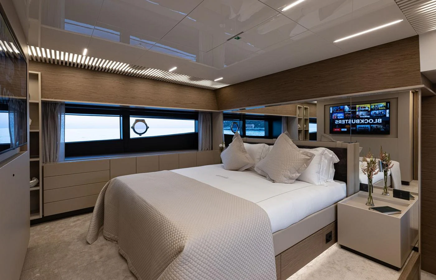 The master stateroom features a luxurious bed with modern decor and ample natural light. aboard ALEGRIA II Yacht for Sale