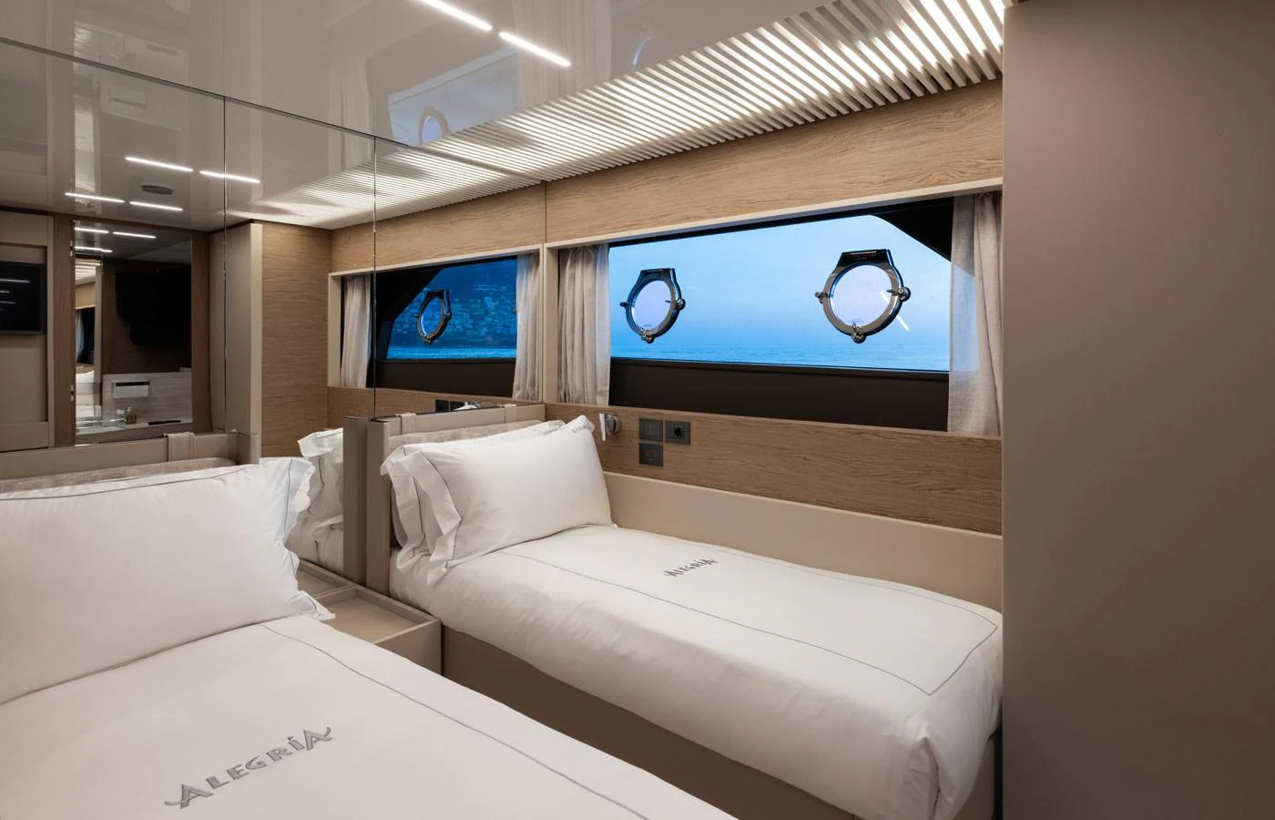 The guest stateroom features twin beds with a serene view of the ocean through large windows. aboard ALEGRIA II Yacht for Sale