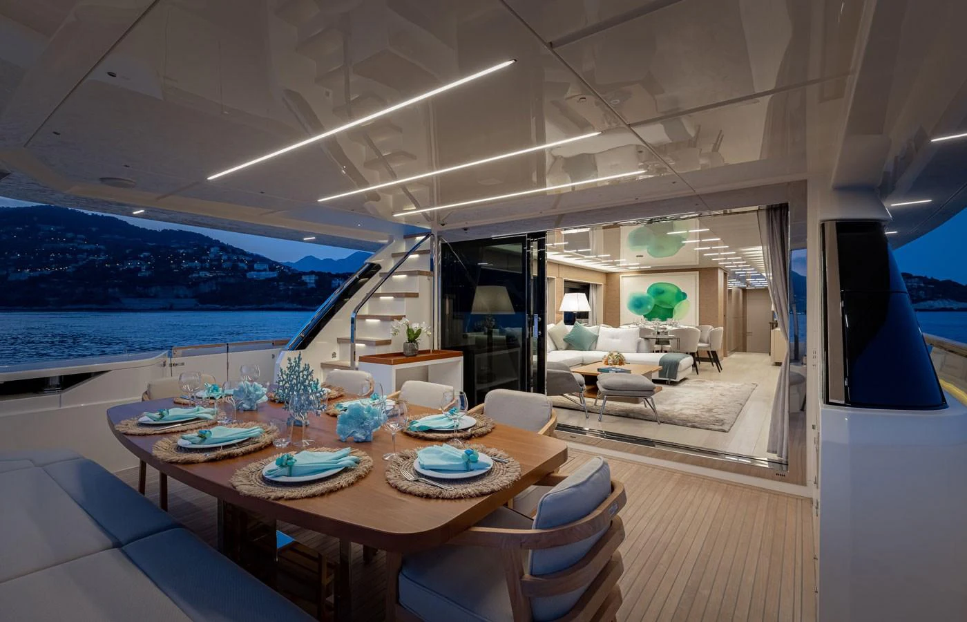 The aft deck features an elegant dining area with a view into the luxurious salon. aboard ALEGRIA II Yacht for Sale