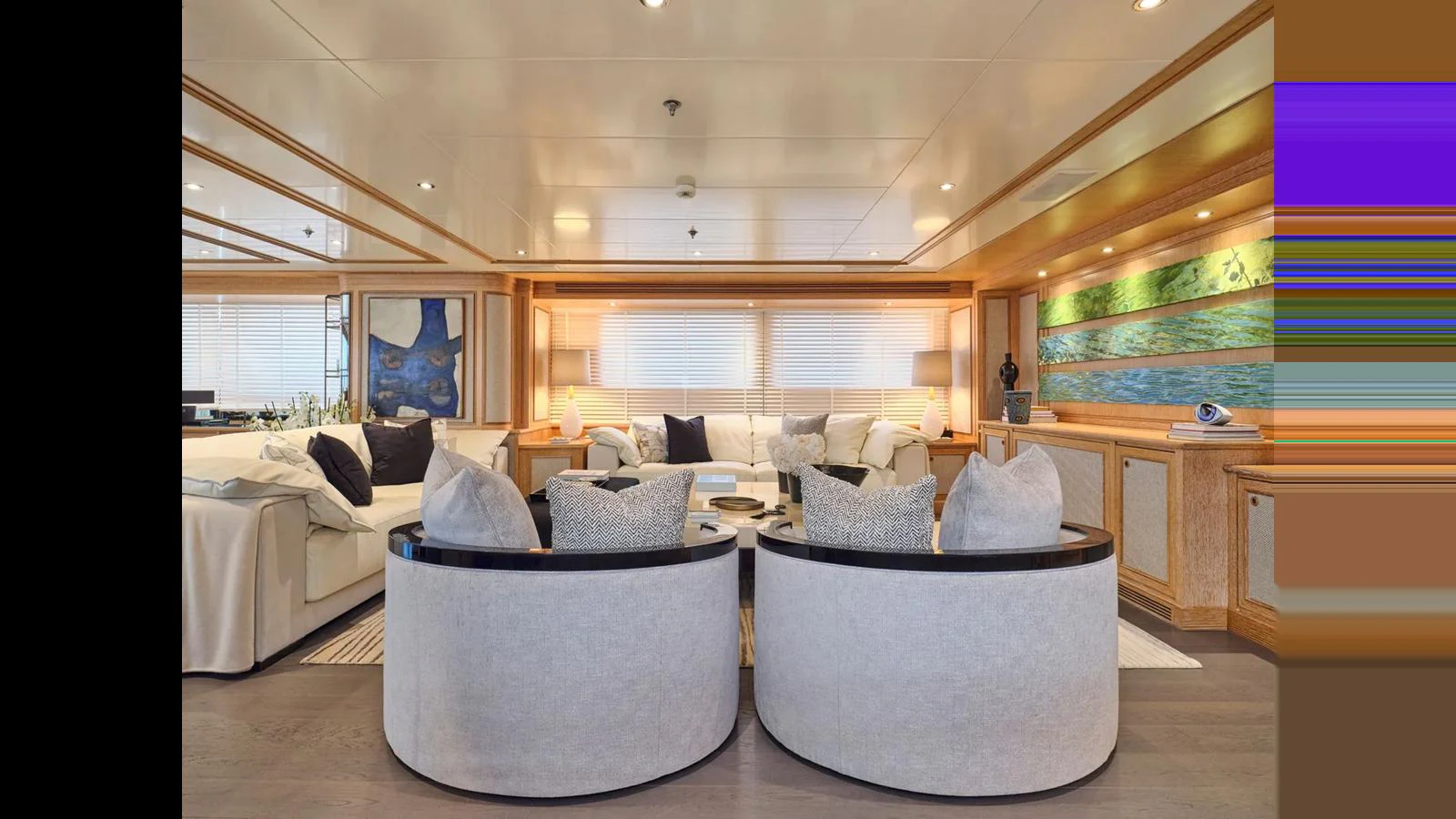 The salon features elegant seating with plush cushions and a sophisticated ambiance. aboard THEOLINA Yacht for Sale