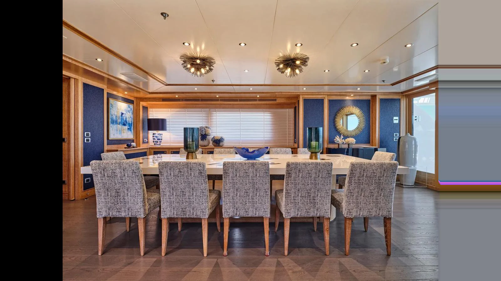 The yacht's dining area features a large table with comfortable seating and elegant decor. aboard THEOLINA Yacht for Sale