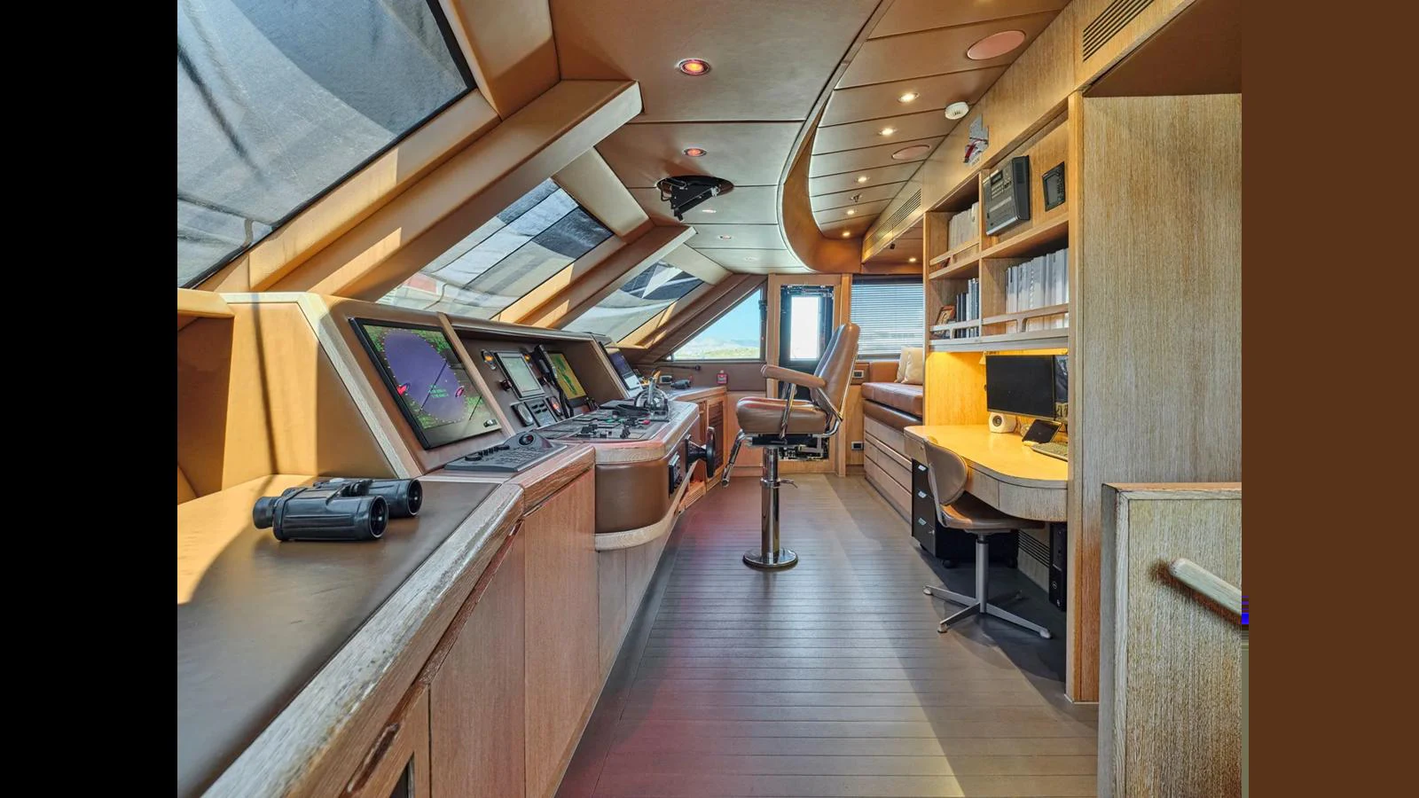 The helm station features advanced navigation equipment and a sleek, modern design. aboard THEOLINA Yacht for Sale