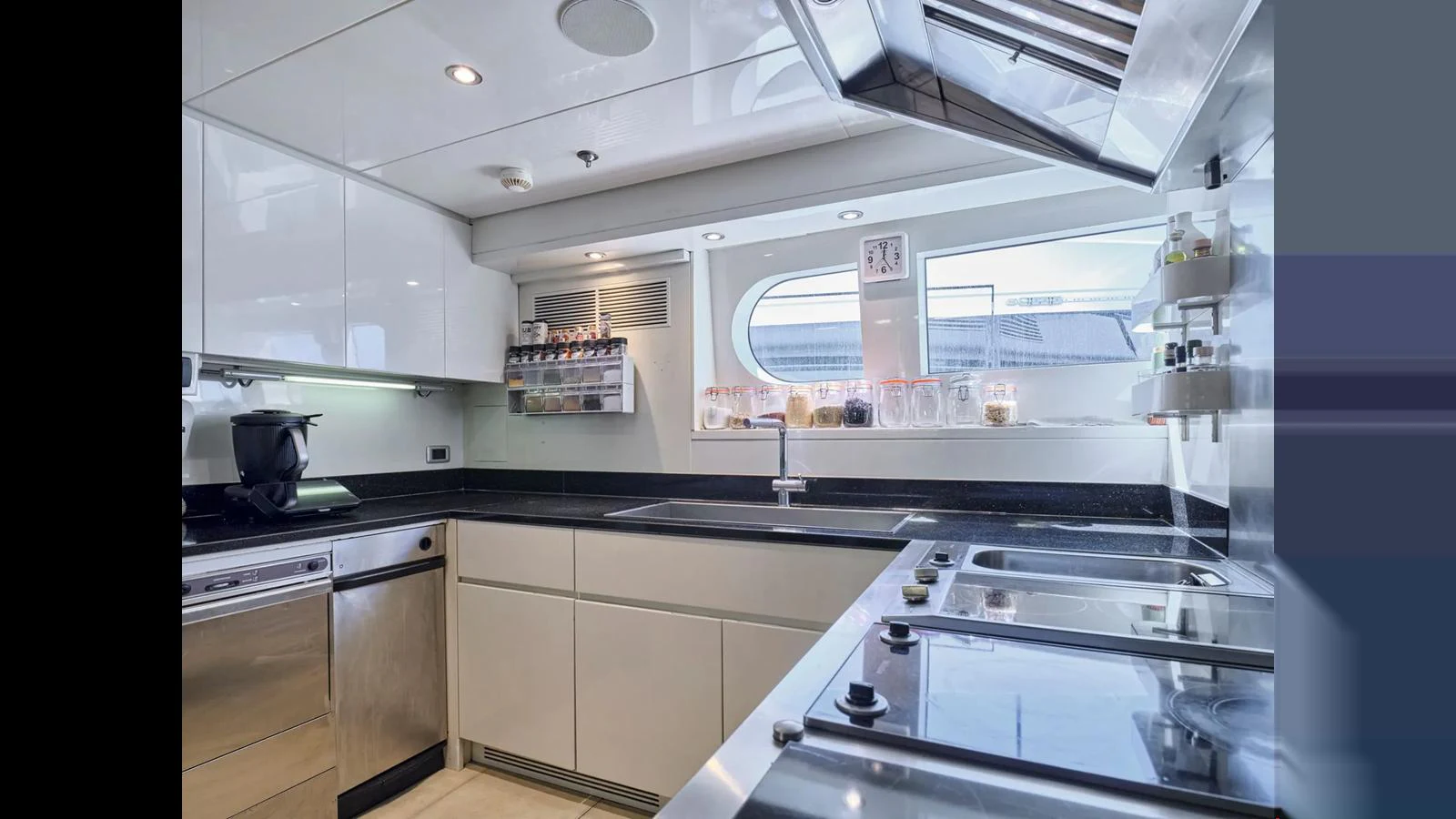 The yacht's galley is equipped with modern appliances and sleek countertops, offering a functional and stylish space for meal preparation. aboard THEOLINA Yacht for Sale