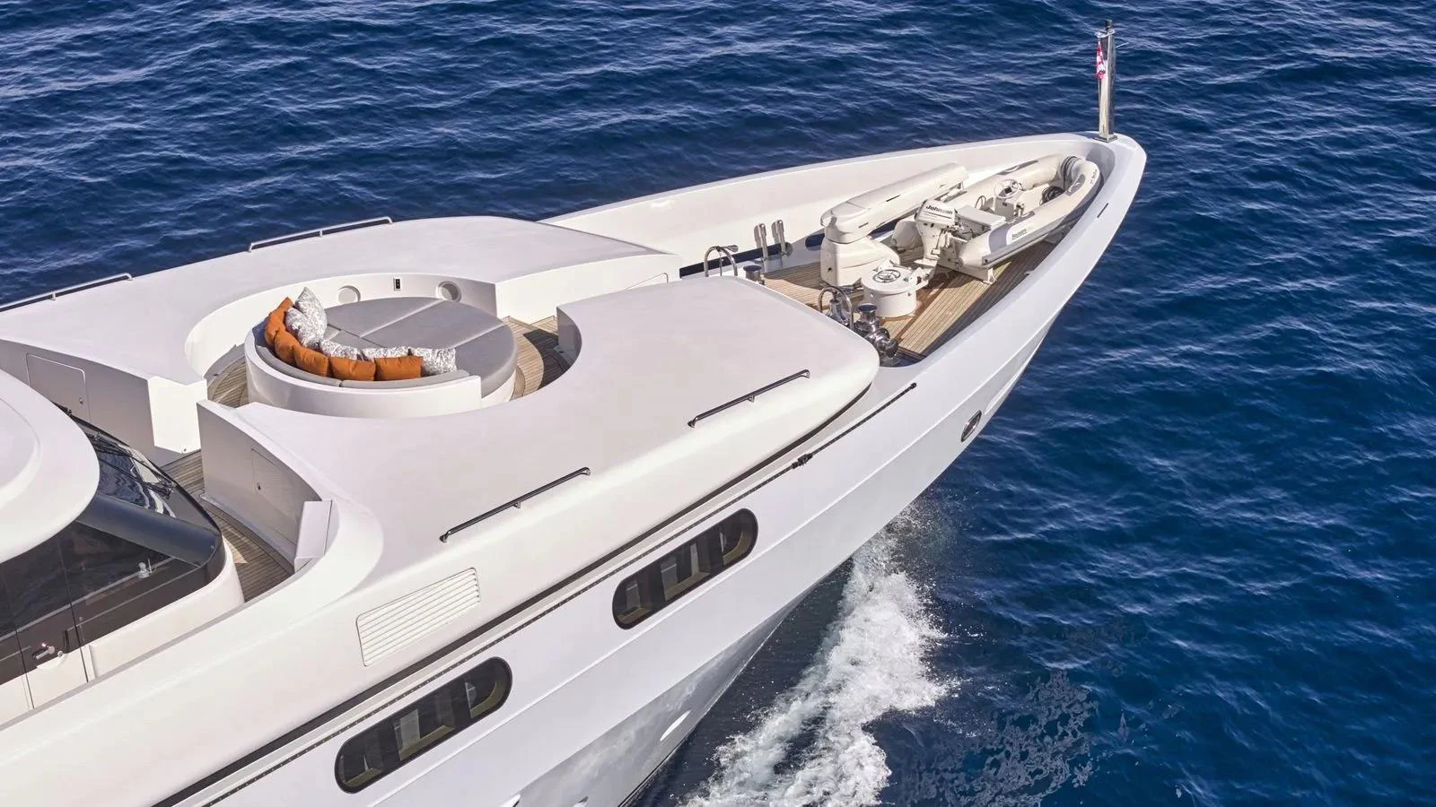 The sleek foredeck of a luxurious yacht glides gracefully through the water. aboard THEOLINA Yacht for Sale